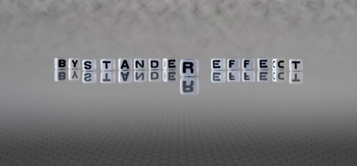 Wall Mural - bystander effect word or concept represented by black and white letter cubes on a grey horizon background stretching to infinity