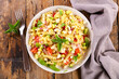 mixed pasta salad with tomato,  basil and cheese