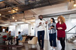 © Westend61 - Young businesswomen talking to colleague in office asking for advice