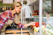 © djoronimo - Woman works in fruits and vegetables shop. She is examining goods.