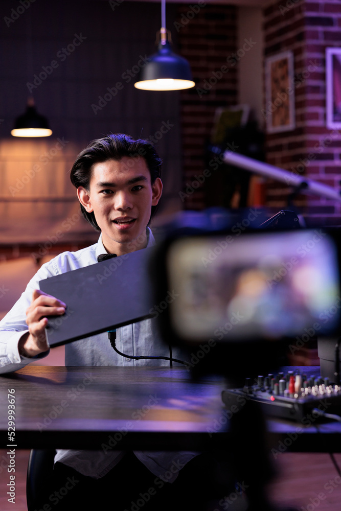 Content creator recording laptop recommendation for social media ...