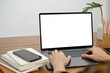 © bongkarn - A man's hands are typing on a laptop keyboard, using a laptop. notebook laptop white screen mockup
