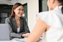 Asian Female Business Consultant Or Insurance Agent Meets With Her Female Client