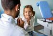 Healthcare medical exam people child concept. Close up of happy girl and doctor with stethoscope
