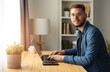 © MYDAYcontent - Portrait of bearded man freelancer working on laptop from home, coding remotely work