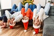 © Krakenimages.com - Group of young people celebrating christmas lying on de sofa with funny position at home