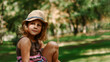© Anastasiia K. - Girl in a straw hat outdoors. Portrait of a cute girl 5 years old. The child is sitting in the park. Copy space.