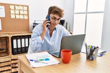 Sticker - Young caucasian man talking on the smartphone working at office