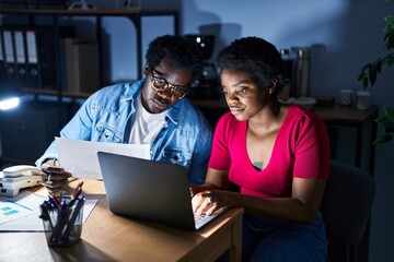 Canvas Print - African american man and woman business workers using laptop working at office