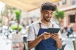 © Krakenimages.com - Young arab man waiter using touchpad working at restaurant