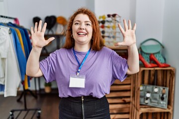 Poster - Young redhead woman working as manager at retail boutique showing and pointing up with fingers number ten while smiling confident and happy.