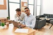 © Krakenimages.com - Two hispanic men business workers smiling confident working at office