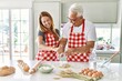 © Krakenimages.com - Middle age hispanic couple smiling happy cooking bread at the kitchen.