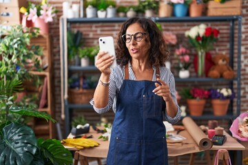 Sticker - Middle age woman florist smiling confident having video call at flower shop