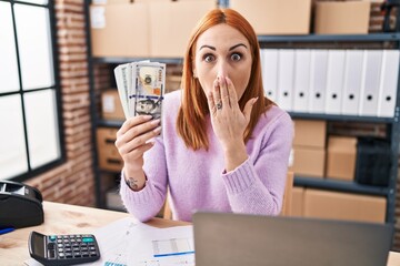 Sticker - Young woman working at small business ecommerce holding money covering mouth with hand, shocked and afraid for mistake. surprised expression