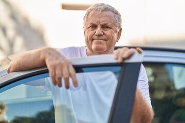 Canvas Print - Middle age grey-haired man smiling confident leaning on car door at street