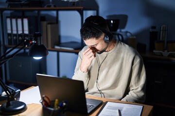 Poster - Young handsome man working using computer laptop at night tired rubbing nose and eyes feeling fatigue and headache. stress and frustration concept.