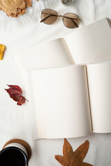 Wall Mural - white blank book with autumn leaves and cup of hot tea on old table , mockup design