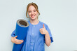 © Asier - Young caucasian physiotherapist holding a mat isolated on blue background smiling and raising thumb up
