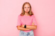 © Asier - Caucasian teen girl isolated on pink background blows cheeks, has tired expression. Facial expression concept.