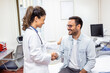 © Graphicroyalty - Smiling young female doctor shake hand close health insurance deal with elderly patient at consultation in hospital. Happy woman GP handshake greeting get acquainted with man in clinic.