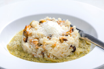 Wall Mural - risotto with mussels, sauce and parmesan cheese