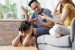 © momolelouch - Portrait of Asian little girl close her ear while her parents have a fight in living room for domestic violence concept