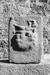 Wall Mural - Black and white photo showing in close-up an ancient sculpture carved in a piece of stone representing a naked woman laying down in a sensual pose