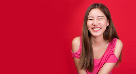 Wall Mural - Happy young asian woman Smilling and look at camera of a comfortable woman with relaxing on red background and copy space Toothy smile girl laughing She is humor female Young lady get in a good mood