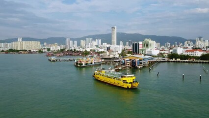 Wall Mural - Penang, Malaysia: Aerial drone footage of the RORO car ferry George Town in Penang island toward Butterworth in Malaysia. Shot with a tilt down motion