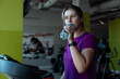 © Татьяна Волкова - Tired overweight girl run on treadmill at fitness gym and drink sip of water from bottle. Plus size woman do cardio workout on exercise machine. Weight loss, thirst, gym membership, sport lifestyle
