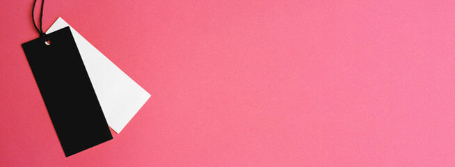 Blank tags on pink background, top view with space for text. Banner design