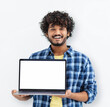 © kucherav - Happy Indian man student standing with open laptop with blank white mockup screen on white background, looking at camera and smiling
