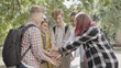 © Synthex - Multiethnic school friends stacking hands, ready to work in team, togetherness