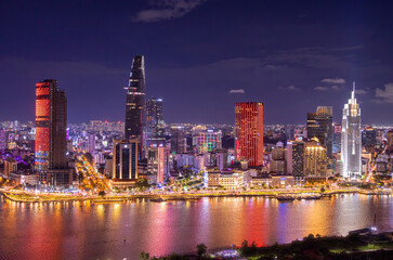 Aerial view of Bitexco Tower, buildings, roads, Thu Thiem 2 bridge and Saigon river in Ho Chi Minh city - Far away is Landmark 81 skyscraper. Travel concept.