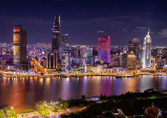 Aerial view of Bitexco Tower, buildings, roads, Thu Thiem 2 bridge and Saigon river in Ho Chi Minh city - Far away is Landmark 81 skyscraper. Travel concept.