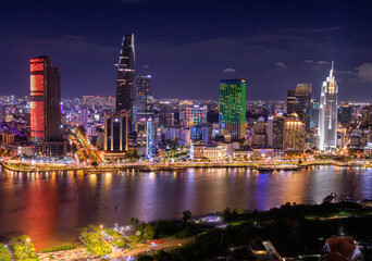 Aerial view of Bitexco Tower, buildings, roads, Thu Thiem 2 bridge and Saigon river in Ho Chi Minh city - Far away is Landmark 81 skyscraper. Travel concept.