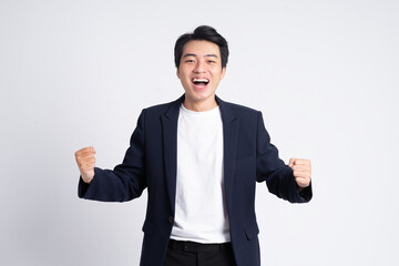 Wall Mural - Young business man wearing a suit posing on a white background