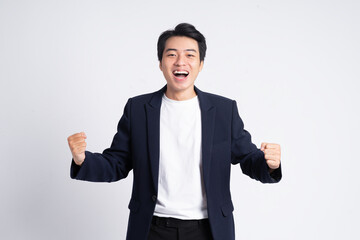 Young business man wearing a suit posing on a white background