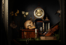 Close-up Still Life, Dutch Painting Of The 17th Century. On The Table On A Black Background Are Flowers, A Skull, A Clock, A Violin, Keys. Things That Tell About A Person's Life.