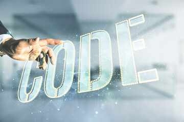 Wall Mural - man hand presses on code word hologram on blurred office background, international software developm