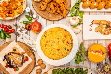 Wall Mural - Recipes of typical Spanish dishes and tapas with potato omelette with vegetables, fried padrón peppers, Cordovan salmorejo, Madirleñas bravas potatoes and other delicious things