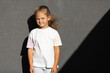 © Ruslan Ivantsov - little girl in white t-shirt. space for your logo or design.