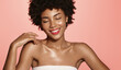 © Liubov Levytska - Skin care. Smiling African American beauty model, girl laughing and smiling, has shiny, clear glowing skin, body after shower, standing over pink background