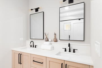 Wall Mural - A new bathroom with a wood vanity, white marble countertop, black faucets, and a view to the marble shower.