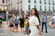 © Cavan Images - Business Latin woman looking at camera surrounded by people