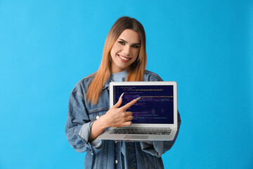 Canvas Print - Transgender programmer with laptop on blue background