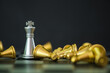 One silver king chess standing and outstanding among the collapse of fall golden chess, business concept able to survive or dominant from destruction. Selective focus.