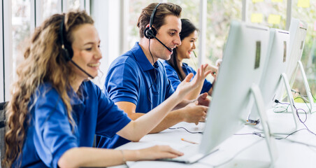 Group of happy call center smiling business operator customer help support team phone services agen working and talking with headset on desktop computer at call center office