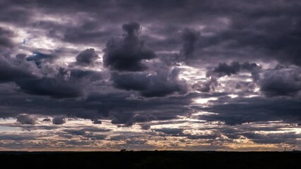 timelapse of dramatic storm clouds moving in the sky over horizon. dark stormy cumulus clouds change